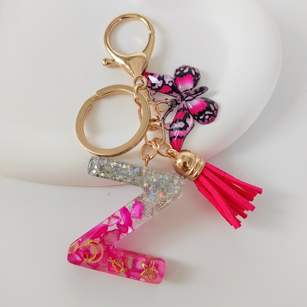 Inventario transfronterizo nueva resina bicolor mariposa borda llavero colgante estrella luna accesorios de joyas