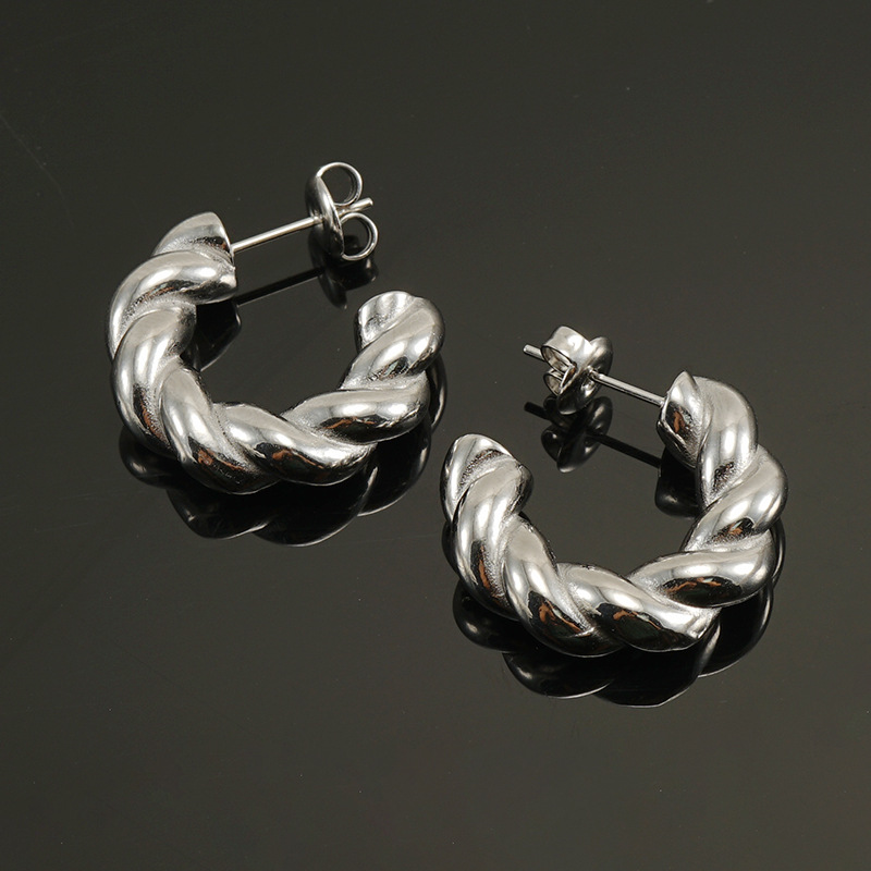 Pendientes de acero de titanio de giro europeo y americano transfronterizo hembra vacío galvanoplastia 18K moda de acero inoxidable torcido pendientes gruesos hembra