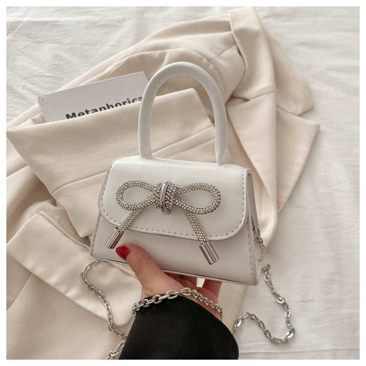 Alta textura estilo Chanel color sólido arco pequeño cuadrado bolso de las mujeres 2023 invierno nueva cadena crossbody del hombro