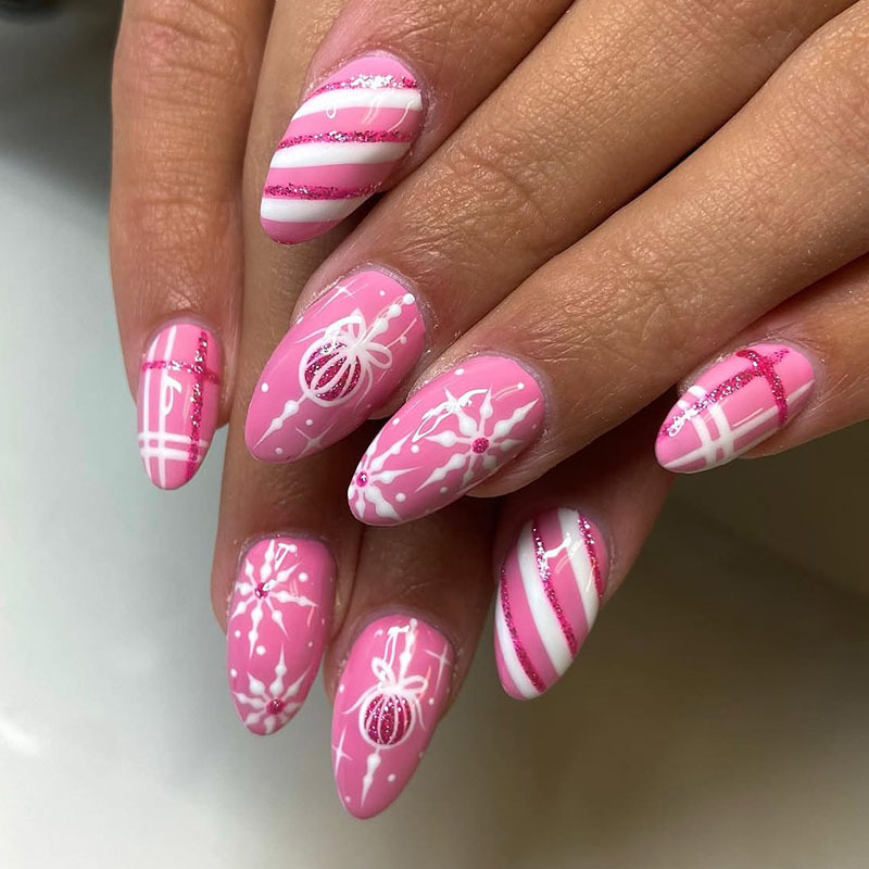 Christmas manicure medium almond-shaped nails, pink nails with plaid patterns, snowflake stripes, glitter, bows, and light balls, fake nails