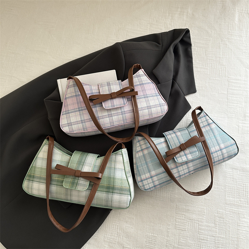 Moda personalidad hermosa versión coreana del bolso de la axila del palo francés 2025 lazo femenino moda nuevo bolso a cuadros de un solo hombro