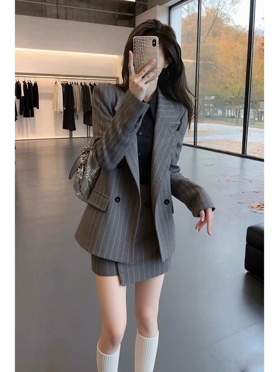 A chic and elegant early spring outfit: a beautiful gray striped two-piece suit for women, perfect for important occasions