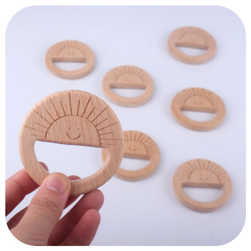 Nuevo bebé suministros juguete de haya mordedor bebé molar mordedor pulsera DIY Smiley sol láser talla
