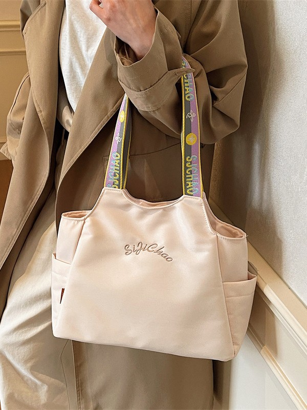 Bolsas de lona de moda de gran capacidad para mujeres 2026 nueva textura bordada letras bolsas de hombro de viaje simple bolsas de mano