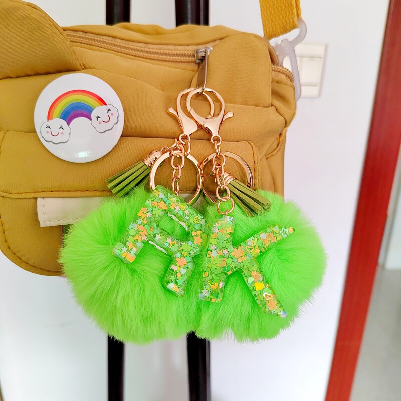 Hot green fur ball letter key chain pendant cross-border e-commerce for two-color drop glue letter tassel pendant
