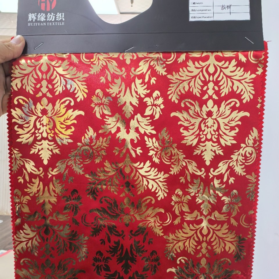 厂家销售涤纶色丁烫金布工艺包边布 金色凤尾花装饰梭织面料批发