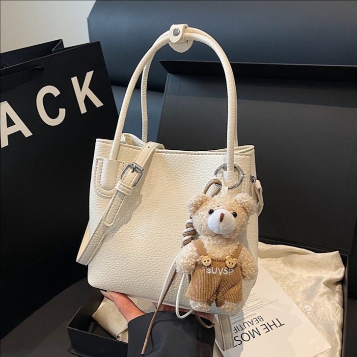 Bolso de cubo portátil de moda coreana para mujer 2025 primavera y verano nuevo bolso de mensajero de un solo hombro casual de alta gama simple