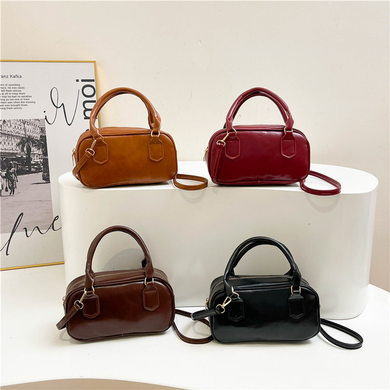 Versión coreana del bolso pequeño de Boston otoño e invierno nuevo bolso portátil para las axilas bolso de bolos literario de moda bolso diagonal de un solo hombro