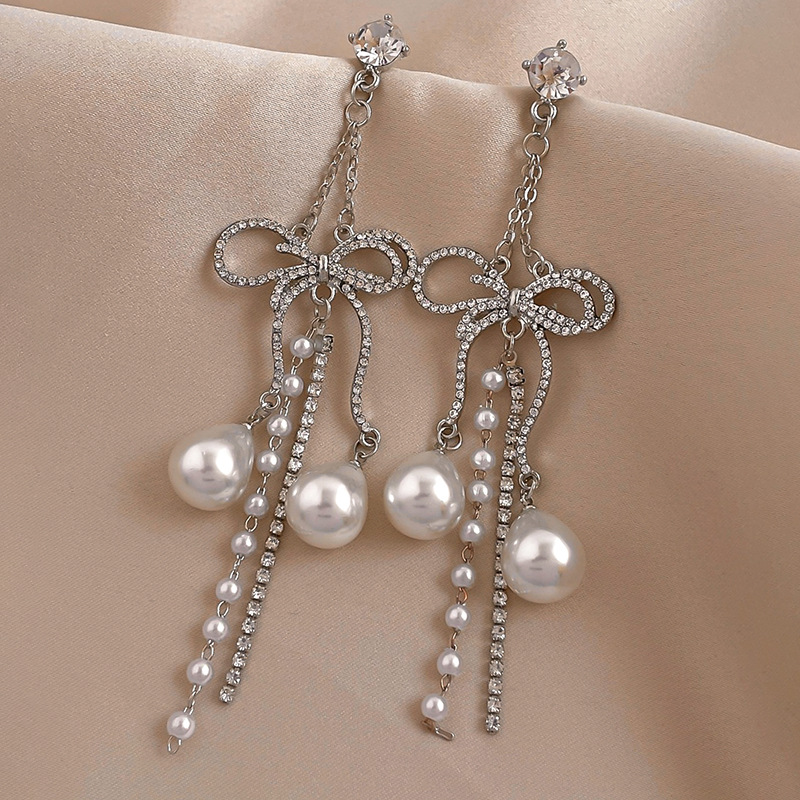 Elegant fashionable earrings with bow pearl with tassels