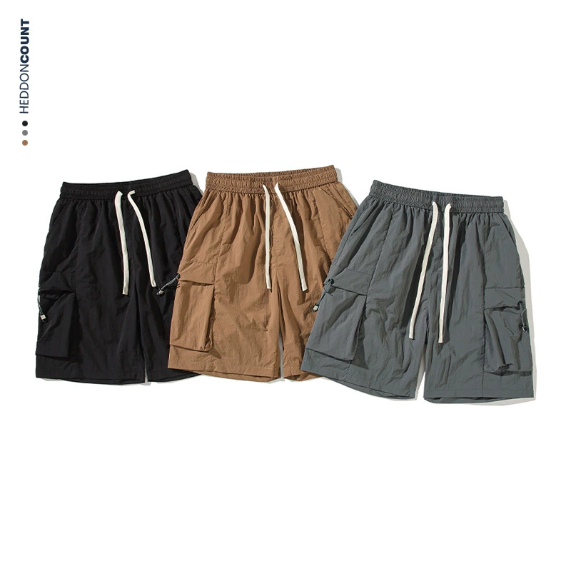 Трехмерный карман для быстрого сушки средние брюки мужской 2025 летний новый сплошной цвет свободные спортивные повседневные перпендикулярные брюки