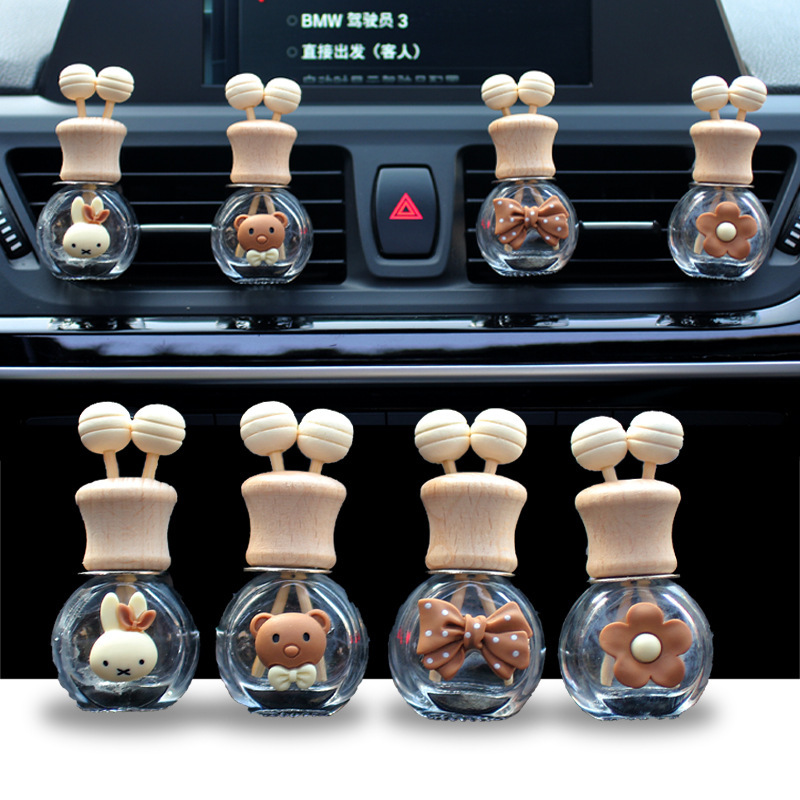 Salida de aire de perfume de coche, dibujos animados, celebridad de Internet, botella de aromaterapia de coche, clip de aire acondicionado, accesorios de coche, bowknot tembloroso