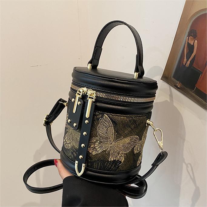 Este año, la nueva popularidad de bolsas bordadas de estilo chino para mujeres 2025 primavera y verano nuevo estilo universal de alta sensación bolsas de cubo de mano