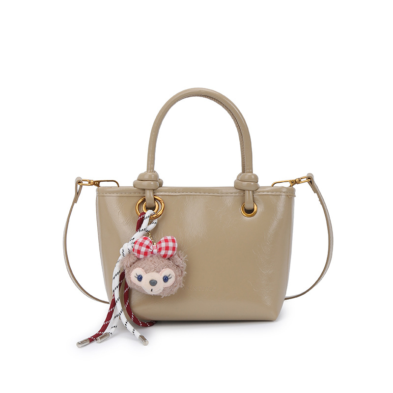 Super caliente versátil bolso de cubo portátil 2025 nuevo popular simple mochila de hombro en línea tendencia explosiva bolso de mujer