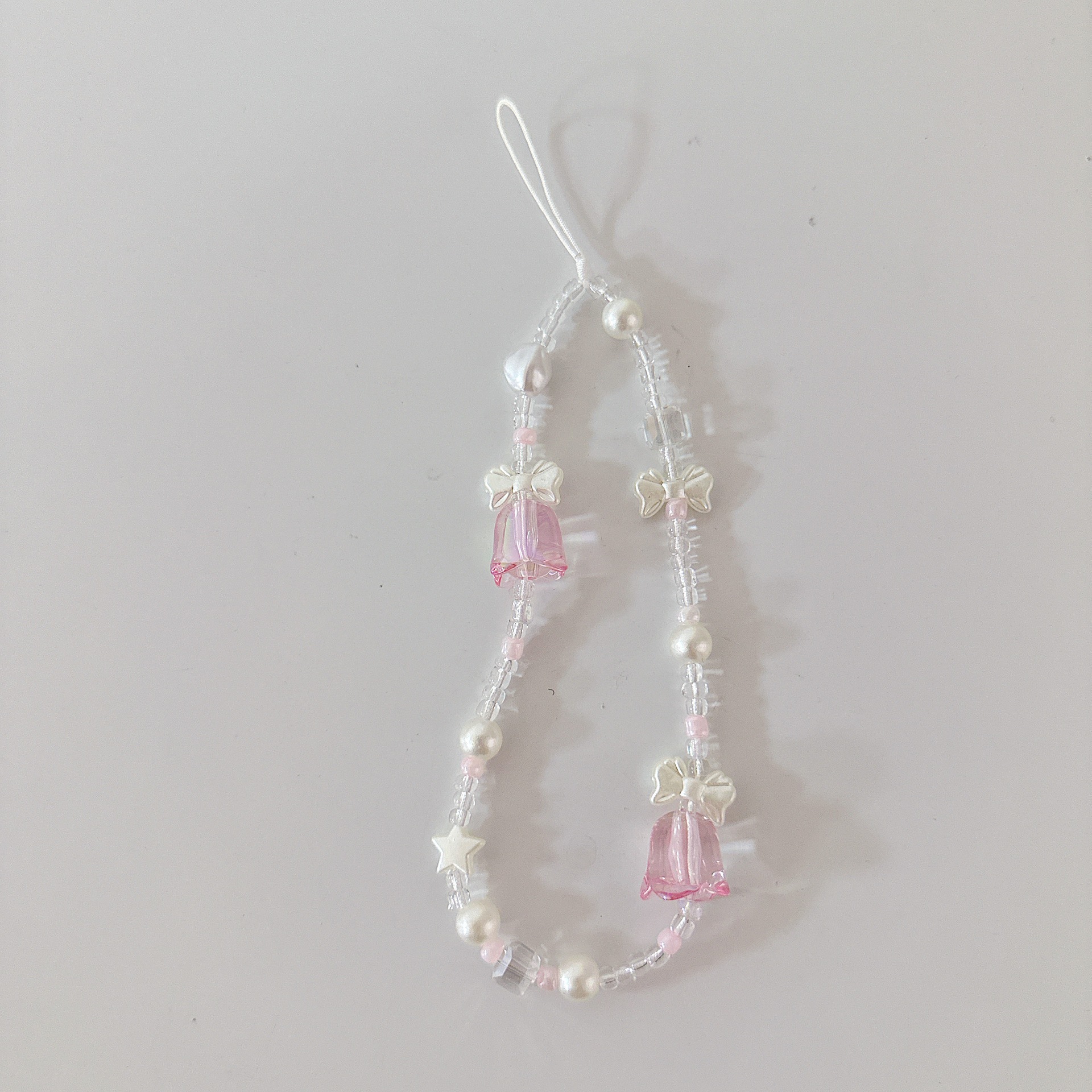 Aplicable cadena coreana orquídea de campana cadena de muñeca arco cuentas de caso de teléfono móvil colgante anti-perdida colgar pulsera trenzada