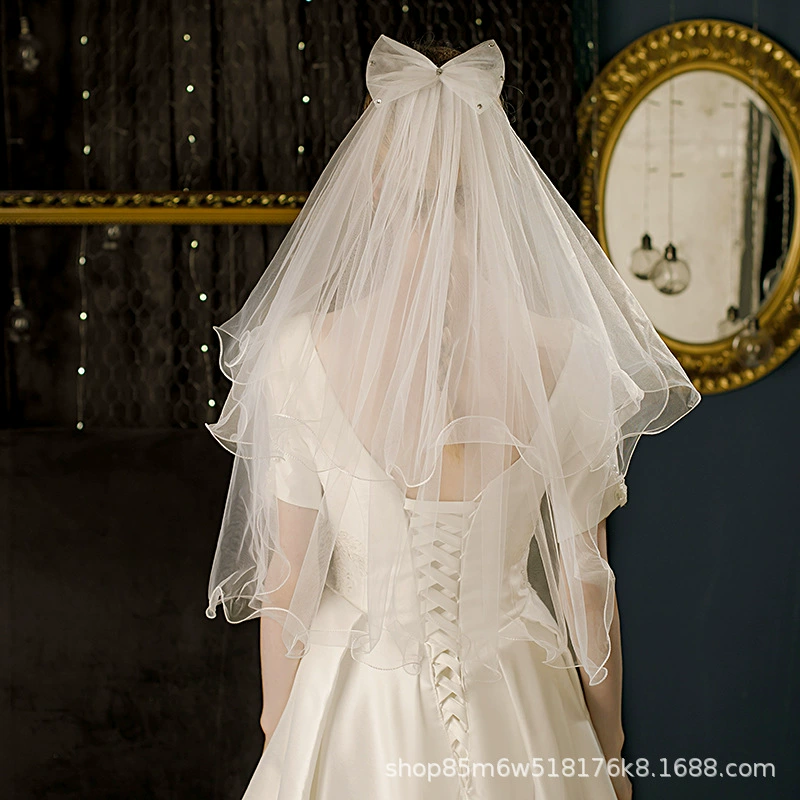 Cute short white bride's veil with bow