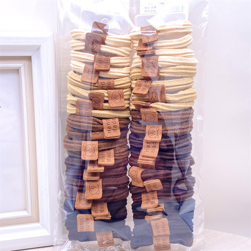 Descuento 4 tarjetas estilo coreano leche té color lindo paño etiqueta banda de pelo banda de goma de las mujeres del lazo del pelo cuerda de pelo 2 yuanes tienda accesorios