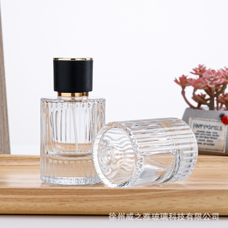 Venta al por mayor 30ml botella de dispensación de perfume cilíndrico 50ml botella de dispensación de loción de rayas verticales botella de rociador de presión botella de perfume