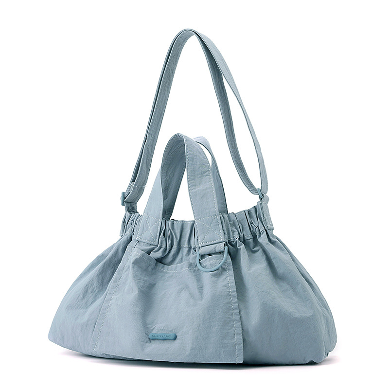 El nuevo diseño de nicho coreano del comercio exterior tiene un sentido del conocimiento de embarque a mano y una bolsa de mujer en el hombro es ligera, casual y plegable.