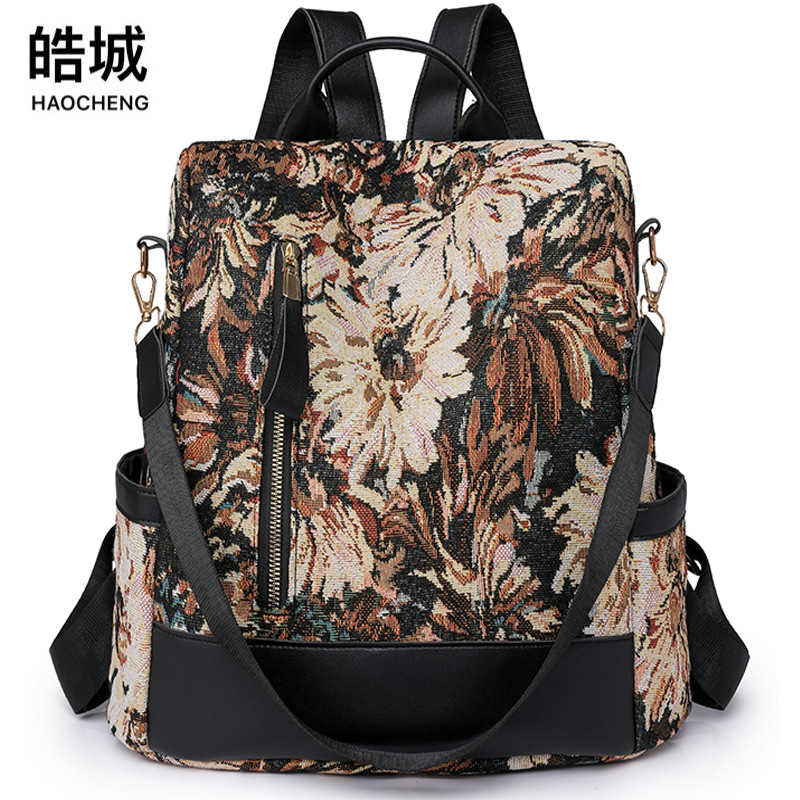 Comercio exterior al por mayor 2023 nuevas señoras casuales mochila antirrobo moda flor nylon color contraste mochila de viaje marea