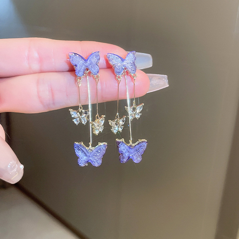 Pendientes de diseño de nicho de moda y exquisito todo fósforo Pendientes de temperamento de hadas Pendientes de borla de mariposa de cristal púrpura