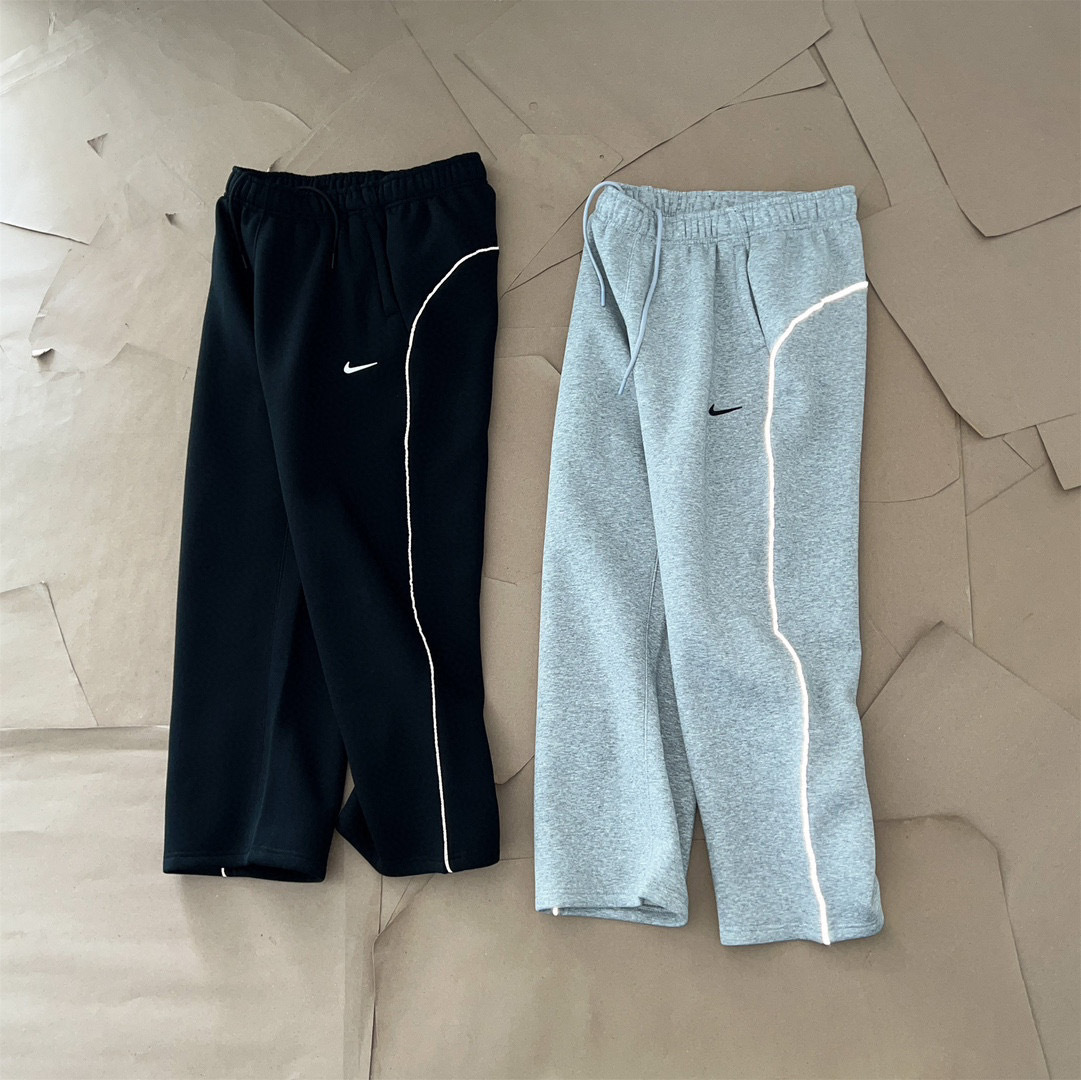 NOCTA collaboration series: 3M reflective strip logo printed on athletic fleece-lined long pants, straight-leg style