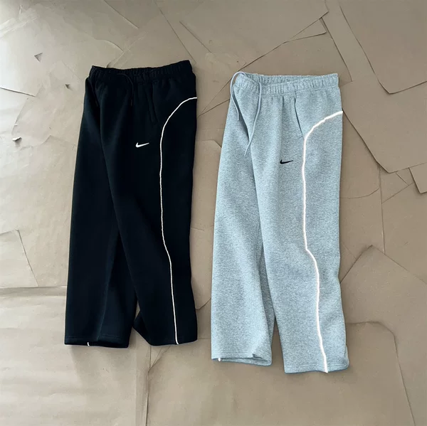 NOCTA collaboration series: 3M reflective strip logo printed on athletic fleece-lined long pants, straight-leg style