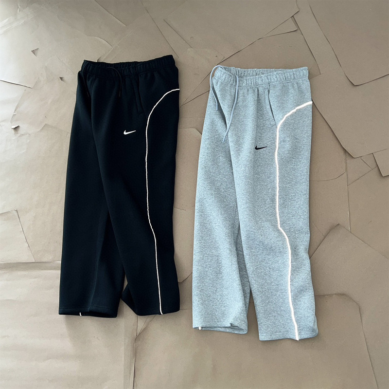 NOCTA collaboration series: 3M reflective strip logo printed on athletic fleece-lined long pants, straight-leg style