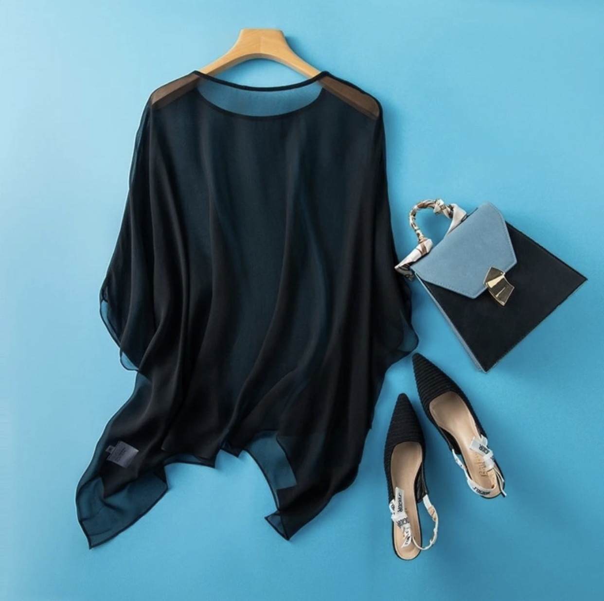 Summer-style elegant bohemian black outerwear cape with a loose round neck and asymmetrical tulle design, perfect for sun protection.