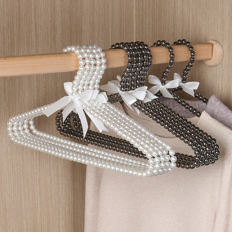 Tienda de ropa de mujer perla lujo ligero vestido retro arco adulto percha de ropa infantil estilo europeo hadas soporte de abrigo