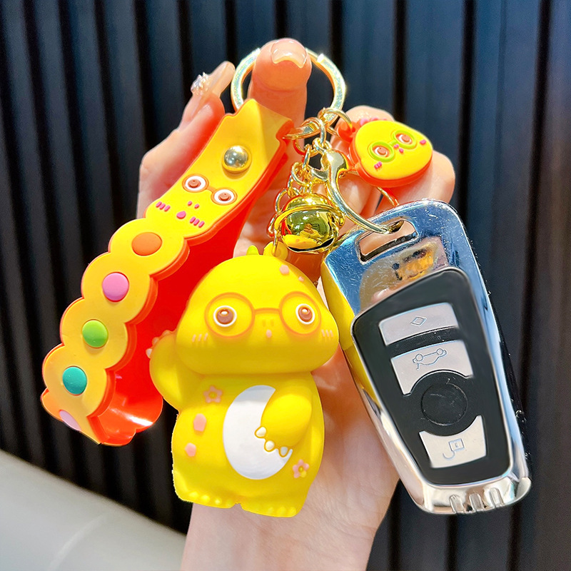 Keychain dinosaurio auténtico lindo bolso colgante de goma blanda llavero de automóvil muñeca pequeña máquina de regalos al por mayor image 4