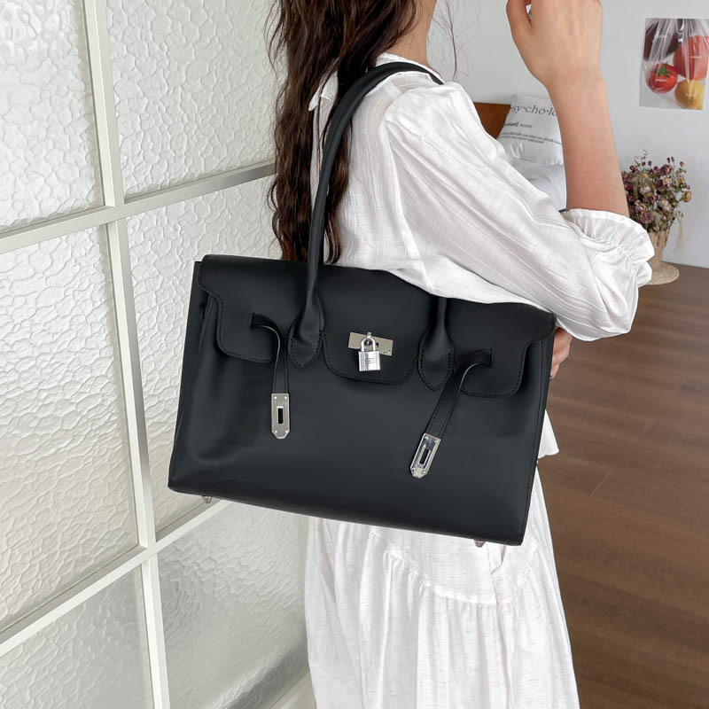 Bolsa de jalea portátil de platino bolso de mujer 2026 verano nuevo PVC color sólido gran capacidad versátil bolso de hombro