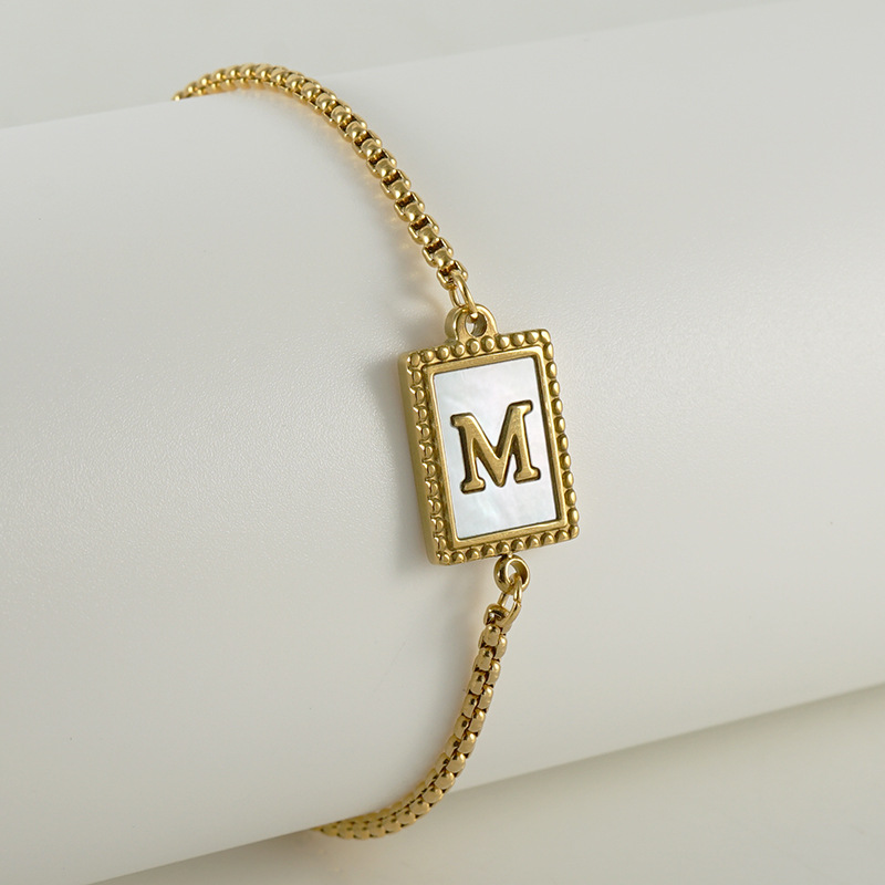 Nuevo europeo y americano transfronterizo de acero inoxidable 26 letras inglesas Shell pulsera personalidad todo partido titanio acero 18K cremallera