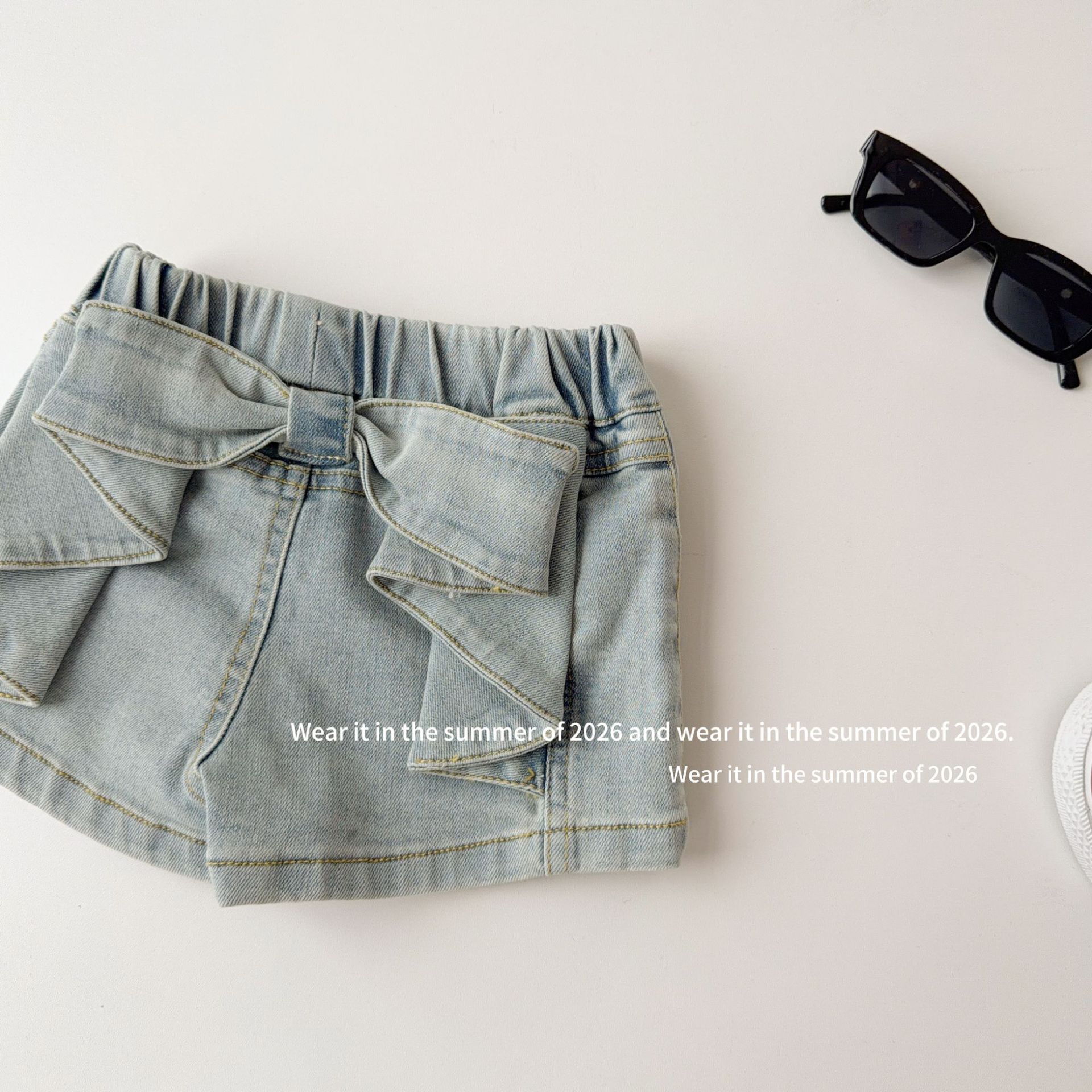 Three dimensional denim skirt with bow