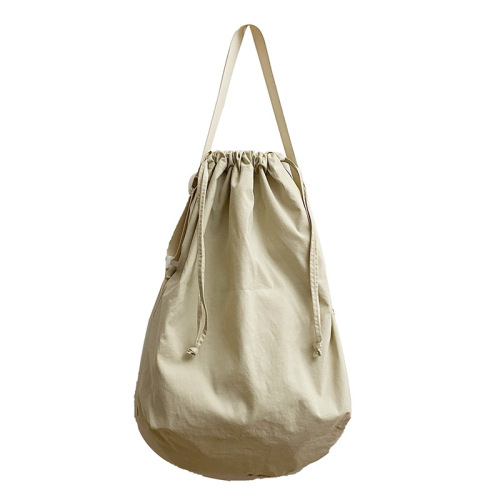 Minimalist drawstring bag for women, new solid color single-shoulder bag, Korean style retro tote bag, suitable for college students, hand-held and cross-body bag for men