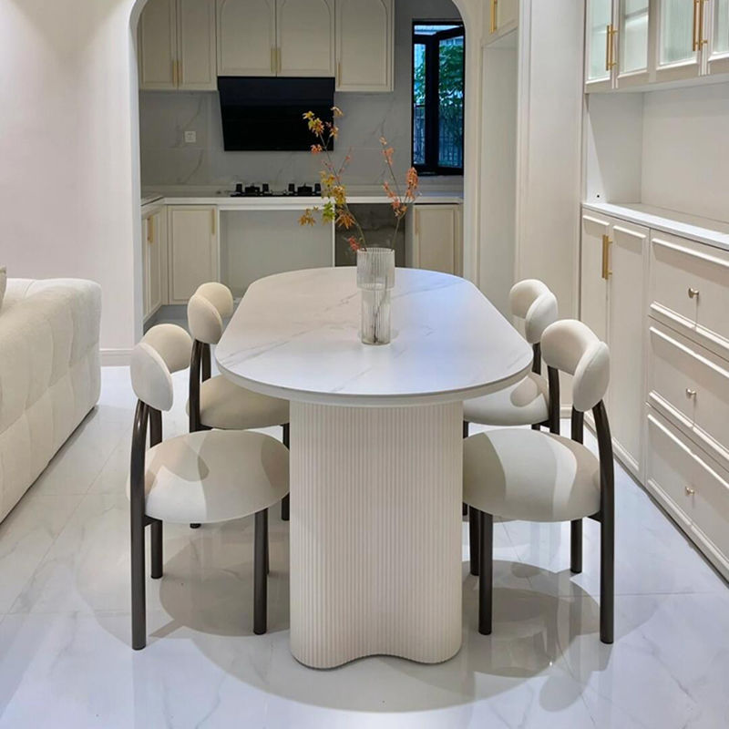Mesa de comedor ovalada de roca francesa lujosa crema de lujo ligera de alta gama moderna y simple columna de cacahuete silla de viento silencioso combinación de mesa de comedor