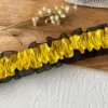 1 meter long, about 4 centimeters wide, golden + black yarn