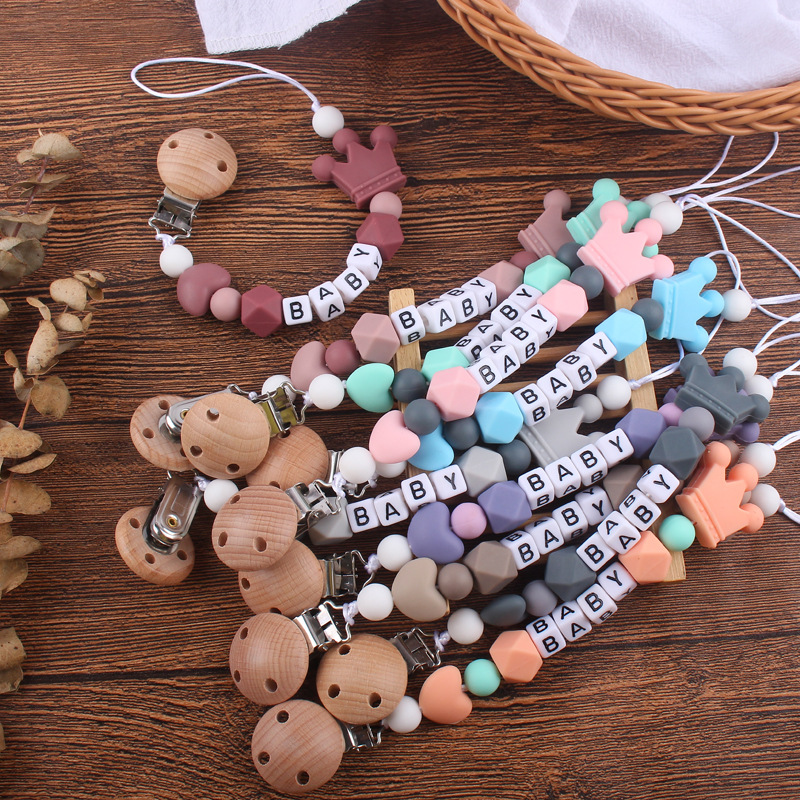 Nuevo bebé haya chupete clip calmante bebé corazón corona de silicona mordedura molar Cadena de chupete cadena anti-caída