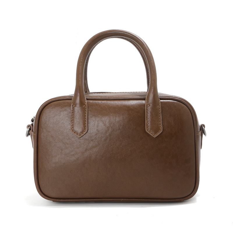 高級感のある植物タンニンなめしの第一層牛革ボストンボウリングバッグ、レディースレトロブラック通勤用ハンドバッグ、ショルダーバッグ、クロスボディバッグ