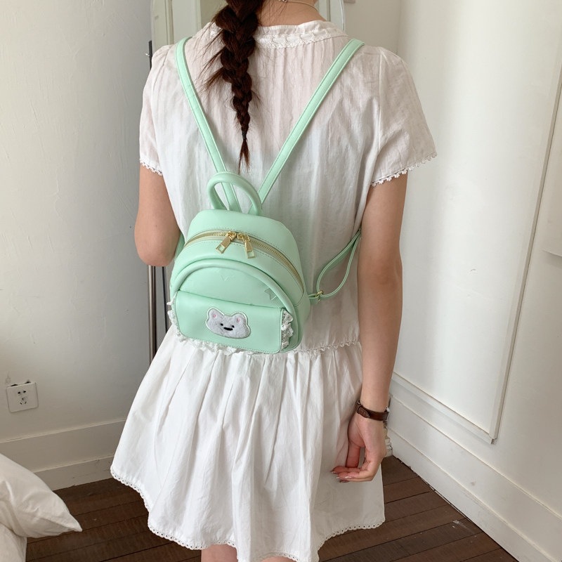 Mujeres nuevas estilos de dibujos animados simples estudiantes 2026 verano universal mochila ligera oso mochila encantador viaje coreano