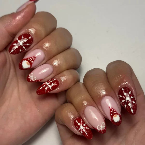 Christmas manicure with medium-sized water drop nails, bowknot, red French nails, Santa Claus, snowflake glitter, and press-on nails
