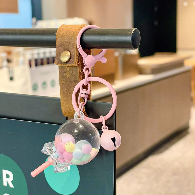 Caricatura en aceite líquido arena flotante botella mochila llavero delicado colgante accesorios accesorios máquina de muñecas pequeños regalos al por mayor