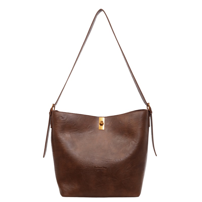 Bolsa de viaje retro coreana para mujeres 2025 invierno nuevo paquete de cubo de hombro de gran capacidad bolsa de mochila casual