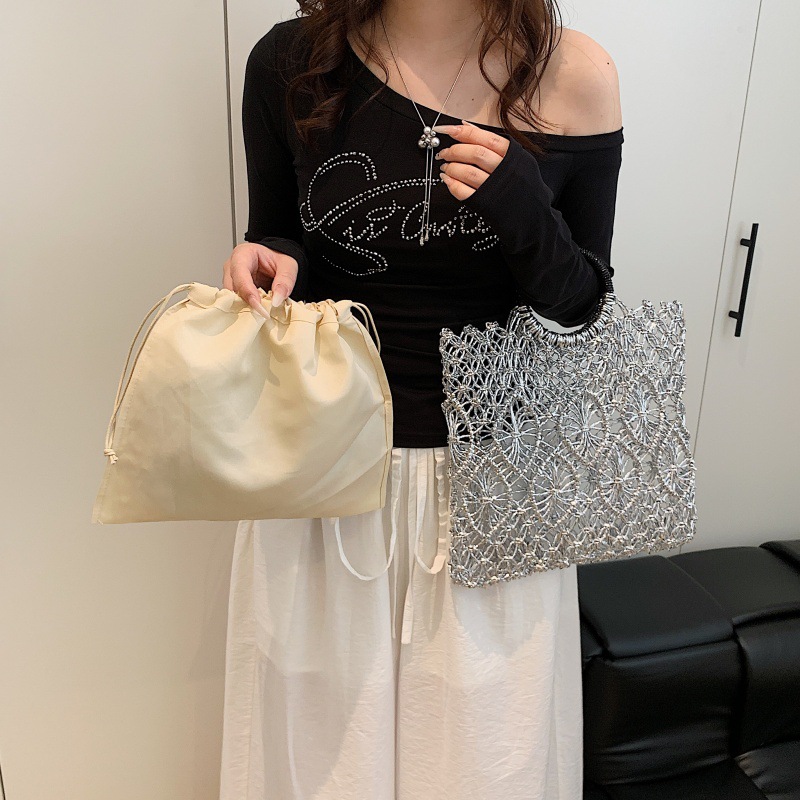 Bolso de vacaciones junto al mar 2025 verano nuevo bolso femenino bolso de playa de estilo occidental bolso tejido hueco de gran capacidad