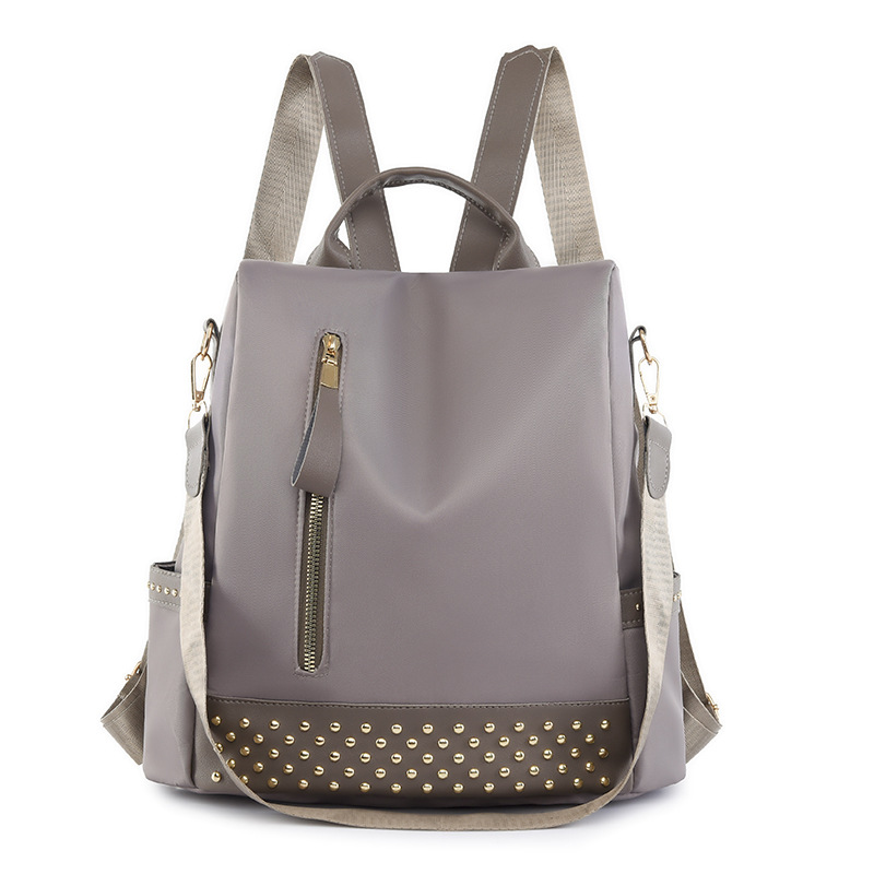 Venta al por mayor 2023 nuevo estilo casual mochila antirrobo mujer simple moda Oxford tela remache mochila escolar de doble uso