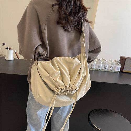 Stylish, versatile drawstring-closure crossbody bag with a minimalist, chic design—perfect for women. Bold-colored, lightweight, and easy-to-hold handbag option.