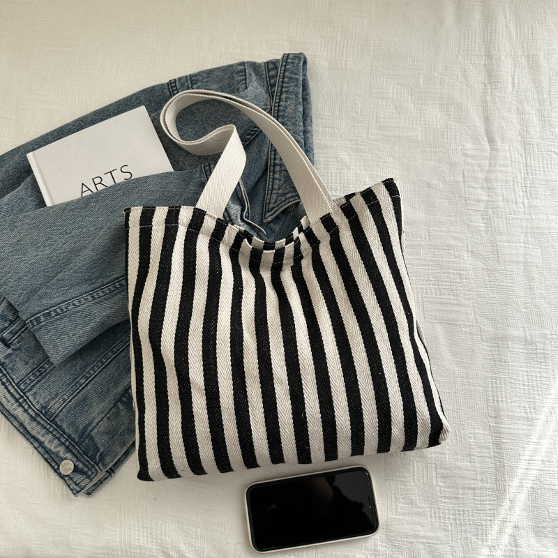 The new cross-border vertical striped commuter tote bag, hand-held shoulder bag, is fashionable and has a large capacity. It features an InS-style simple letter sail undefined