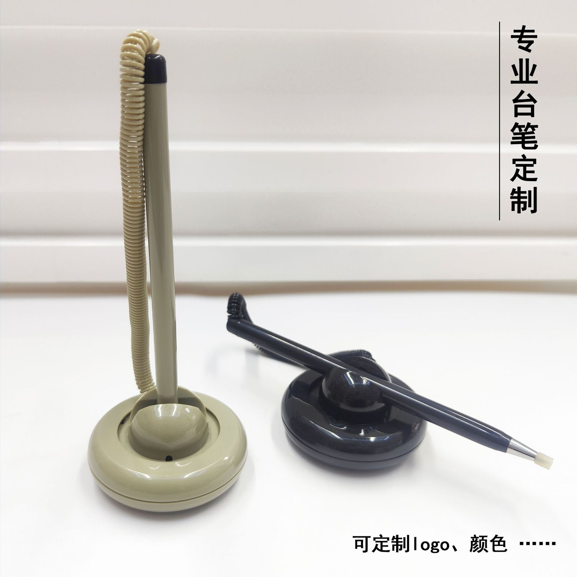 Spring-loaded pen holder for reception desks, featuring a circular design, fixed positioning to prevent loss, customizable logo, and replaceable ink cartridges