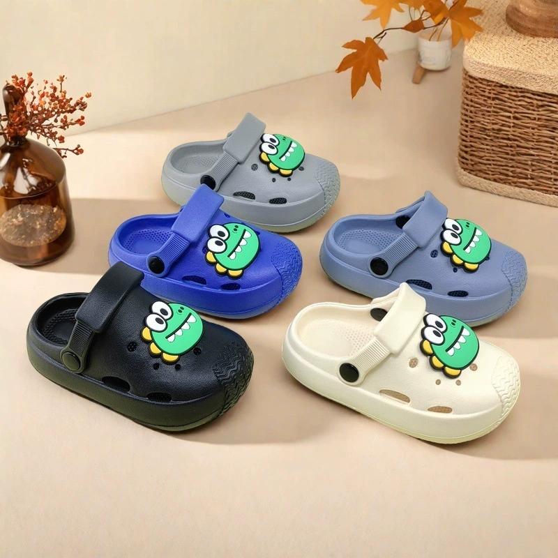 Оптовые новые летние стильные сабо для мальчиков и девочек с мультяшным принтом, модные, повседневные и удобные, домашние и уличные плоские тапочки для ежедневной носки.