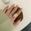 Retro fashionable design ring from pearl, French retro style, on index finger