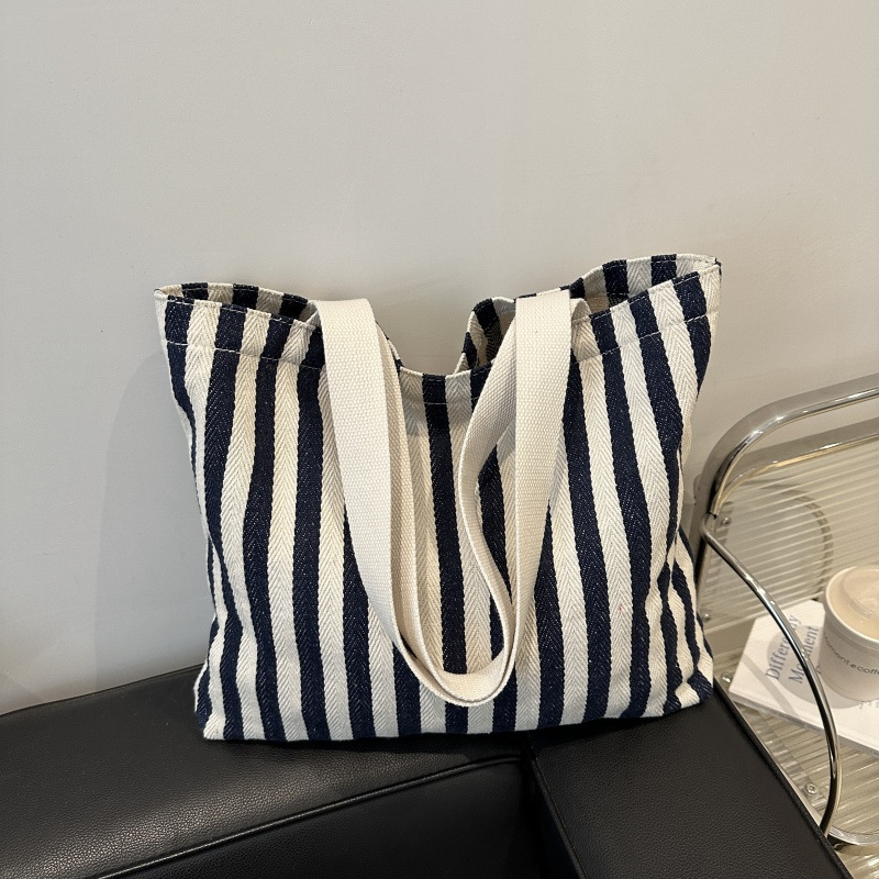 The new cross-border vertical striped commuter tote bag, hand-held shoulder bag, is fashionable and has a large capacity. It features an InS-style simple letter sail undefined